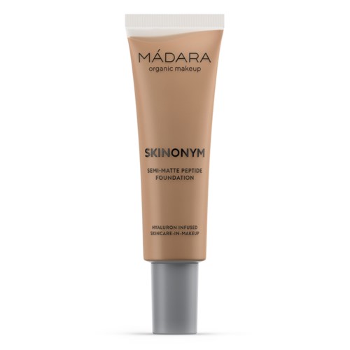 A beige tube of Mádara organic makeup SKINONYM foundation with a silver cap.