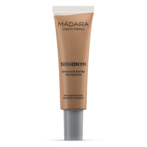 A beige tube with a white cap, labeled 'MÁDARA organic makeup' and 'SKINONYM semi-matte foundation.'