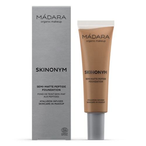 A beige tube of foundation with white cap and matching box, labeled 'MÁDARA organic makeup SKINONYM.'