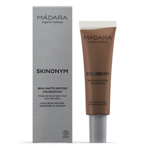 A box and tube of MÁDARA Skinonym semi-matte peptide foundation, labeled as hyaluronic infused, organic makeup with skincare benefits.