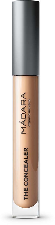 Concealer tube labeled 'MÁDARA THE CONCEALER' with a silver cap and beige product inside.