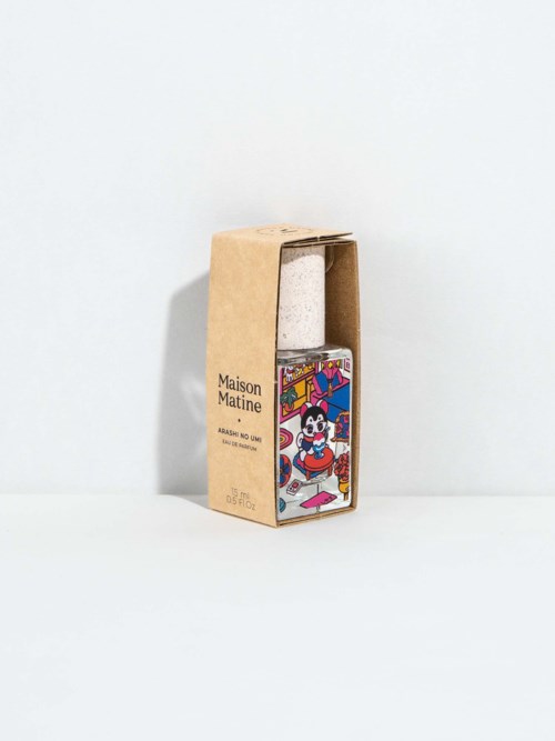 A cardboard box contains a colorful cosmetic bottle with a cartoon character design on it.