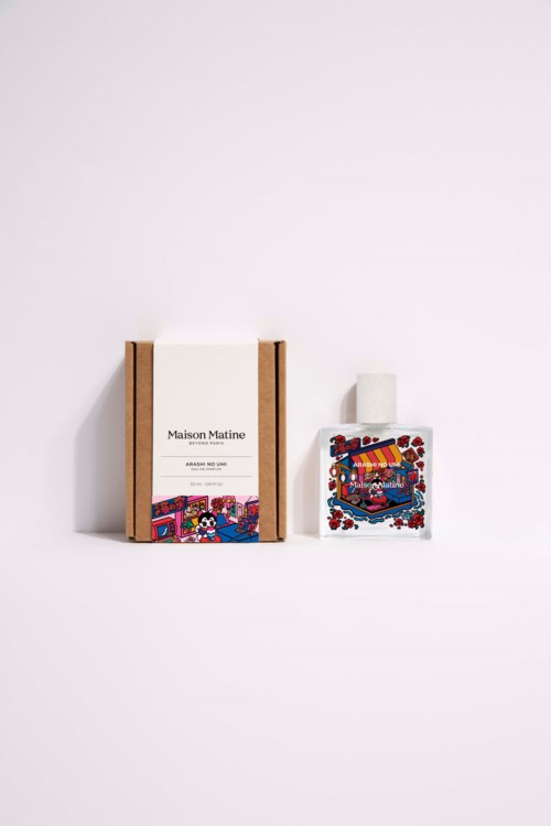 A limited edition perfume packaging with colorful, artistic label and a white box and bottle against a plain white background.