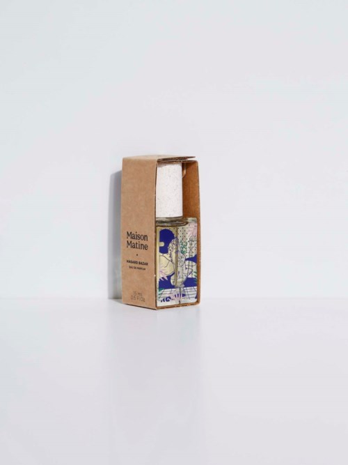A small bottle inside a cardboard box, with a colorful design on the bottle. The box has text on it.