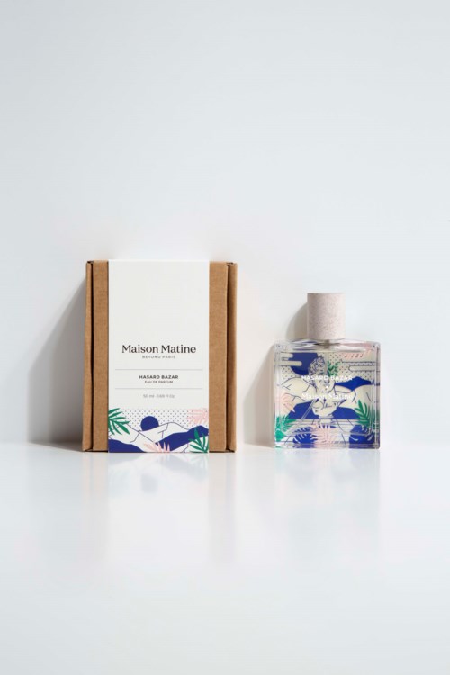 A box, a bottle, and a roll of paper with blue and green designs, all placed on a white surface.