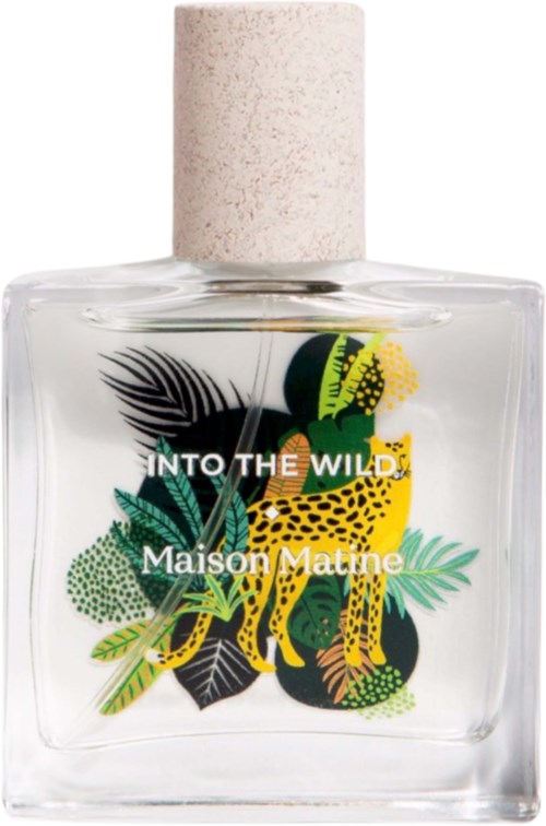 A clear perfume bottle with colorful jungle leaves and a yellow leopard design on the front, labeled 'INTO THE WILD'.