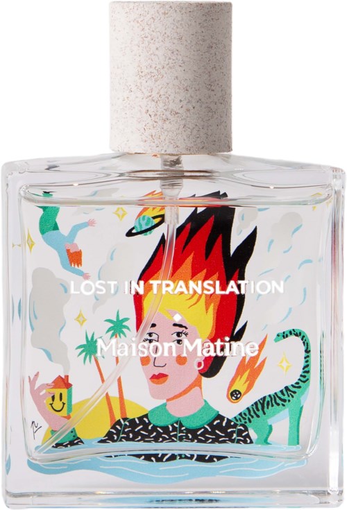 A colorful illustration on a perfume bottle shows a woman with fiery hair, surrounded by animals, stars, and planets.