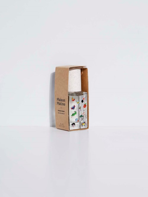 A glass bottle with colorful nature illustrations inside, placed in a cardboard box with text.