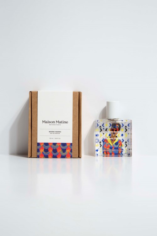 A perfume bottle with colorful artwork and a box labeled 'Maison Matine' on a white background.
