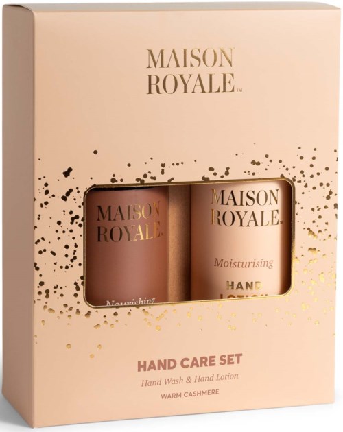 A beige box with gold and black splatters holds two moisturing hand care products in small jars.