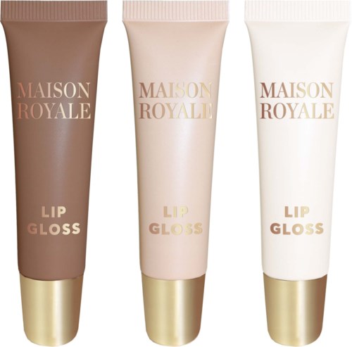 Three tubes labeled 'Maison Royale Lip Gloss' in different shades, light brown, pink, and white, with gold caps.