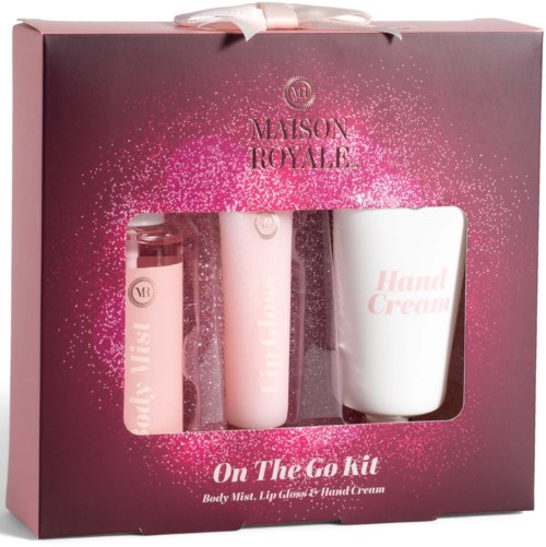 Pink box with three beauty products visible inside: body spray, lip gloss, and hand cream.