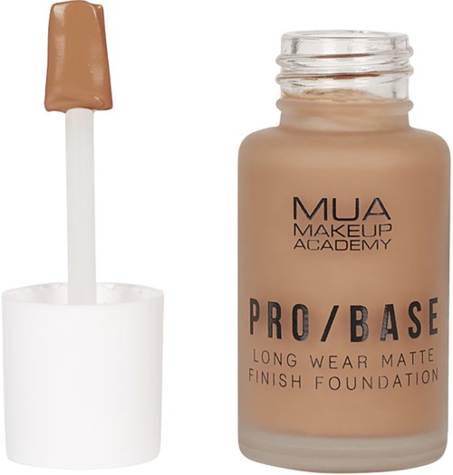 Meikkivoidepullo, jossa beige neste ja valkoinen kansi, ja sivellin esiintyy.