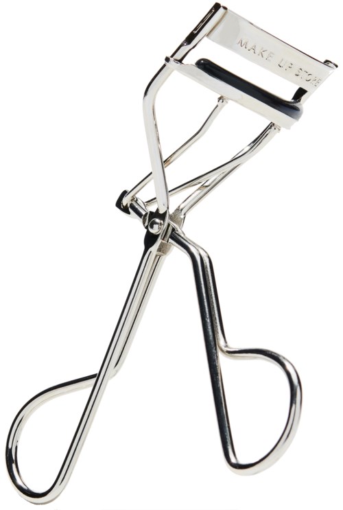 A metallic eyelash curler with a handle and a padded pad for curling eyelashes.
