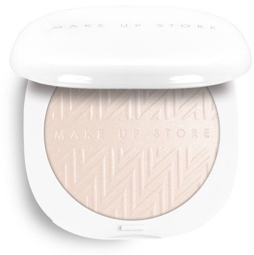 En kompakt ansiktspuder med ett texturerat mönster och märke Make Up Store inpressat på ytan.