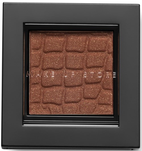 En makeup-palett med bronset ögonskugga i ett svart fodral.