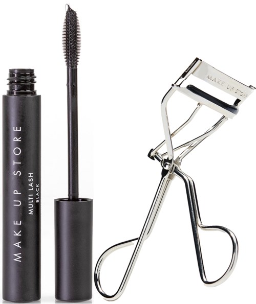 Een zwarte mascara-buis, een mascara-pen en een metalen ooglidklem op een witte achtergrond.