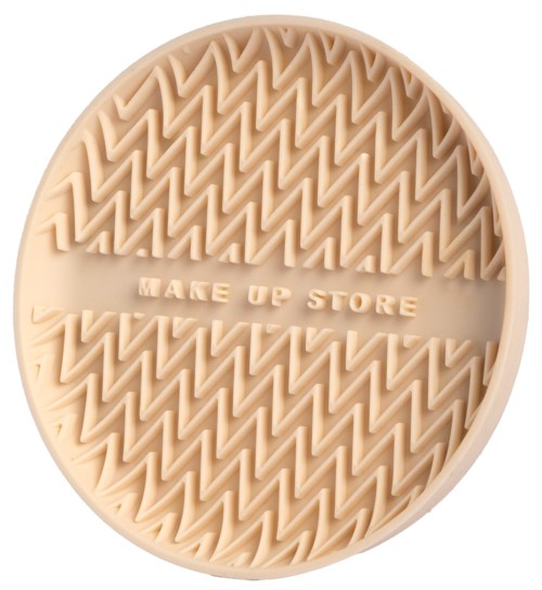 A round beige silicone container with a zigzag pattern and the words "MAKE UP STORE" in the middle.
