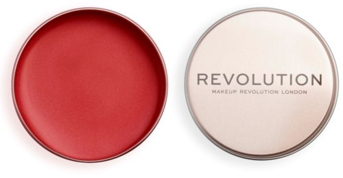 Two round makeup products, one red and open, the other closed with text "REVOLUTION" on it.
