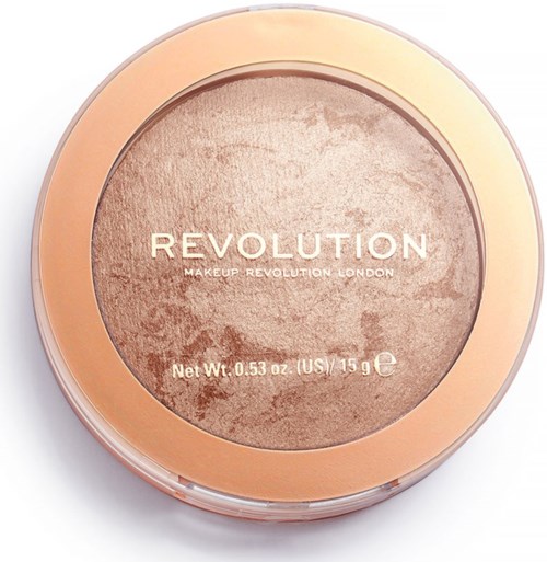 Pyöreä meikkisäiliö, jonka läpinäkyvä yläosa näyttää beigehuokosta sisällä, ja siinä lukee 'REVOLUTION Makeup Revolution London' ja painotiedot.