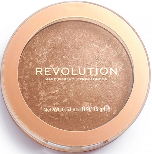 A round makeup product with a clear lid, containing light brown powder labeled 'Revolution'.