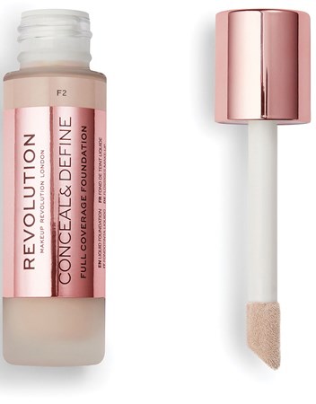 A foundation bottle with a pink cap and applicator sponge, labeled 'Revolution Conceal & Define Full Cover Foundation.'