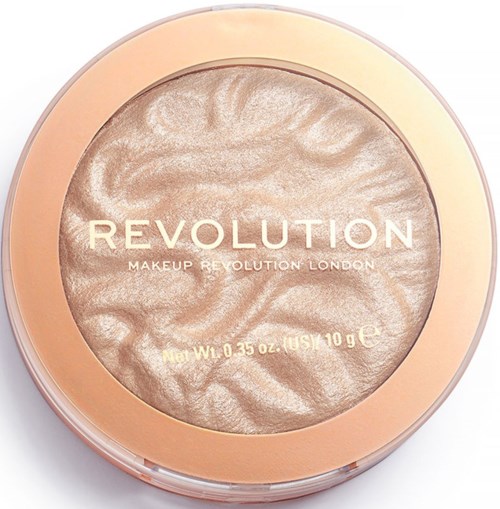 Een ronde make-upproduct met een glanzende beige en goudkleurige oppervlakte, voorzien van 'Revolution Makeup Revolution London' en gewichtsinformatie.
