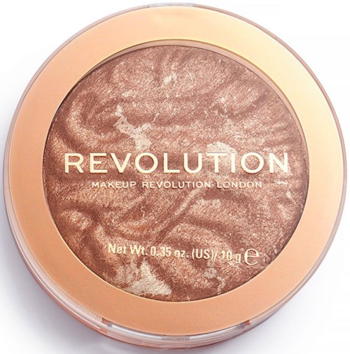 Makeupprodukt från Revolution med ett marmorerat, glänsande brons och guldutförande i ett runt behållare.