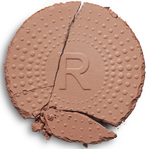 A cracked round tablet with a letter 'R' and dotted texture on its surface.