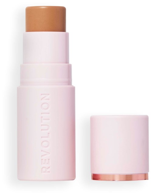 A beige makeup stick inside a pink case with the cap off, showing the product's name on the case.