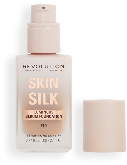 A bottle of Revolution Skin Silk luminous serum foundation with a cap placed beside it.
