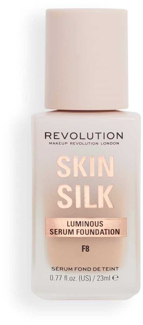 A bottle of foundation labeled 'Skin Silk' by Revolution, with a soft pink and white design and a large cap.