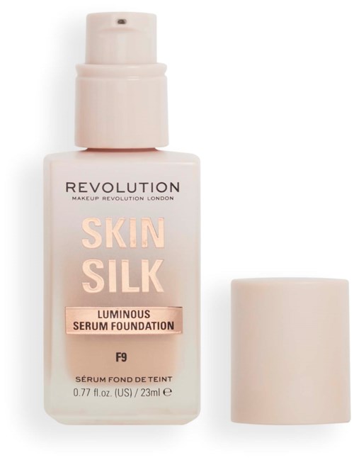 A white foundation bottle labeled 'Skin Silk' with a cap beside it, indicating luminous serum foundation.