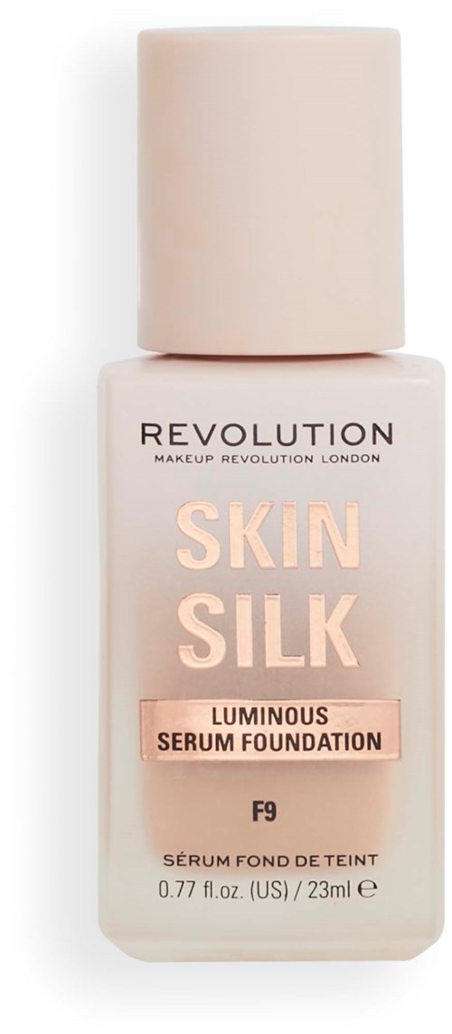 A pastel pink bottle of foundation labeled 'Skin Silk' from Revolution Makeup, with a beige cap.