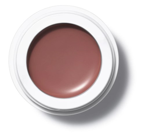 En rund behållare med rosa-brun makeup eller kräm inuti, sedd ovanifrån.