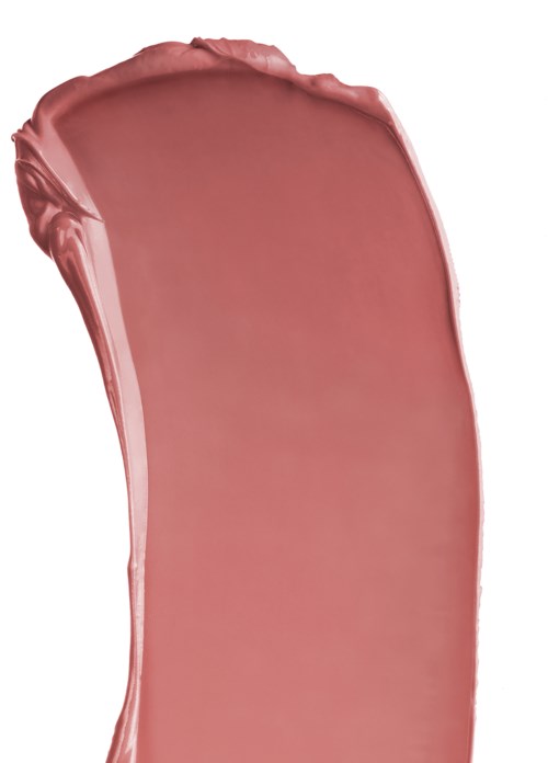 En stor smet av rosa läppstift eller makeupprodukt på en vit bakgrund.
