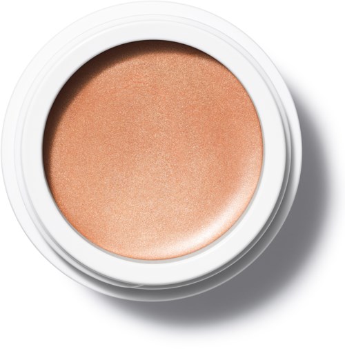 En rund behållare med persikofärgad rouge inuti. Den är öppen, visar makeupprodukten.