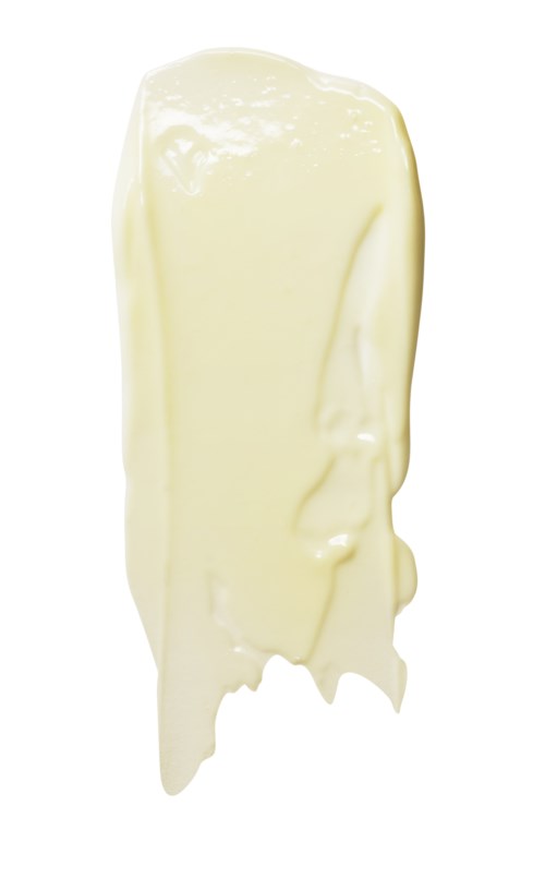 A large streak of melted white chocolate. It is glossy and smooth, hanging down from the top.