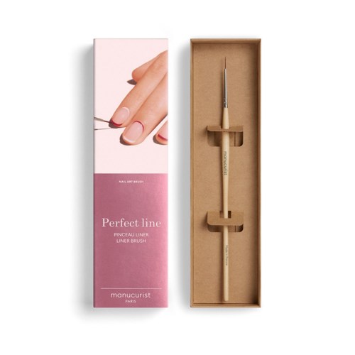 A nail art tool in a cardboard box, with a hand showing a painted nail and a brush inside.