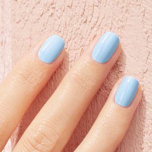 Three fingers with light blue nail polish on a pink textured background.