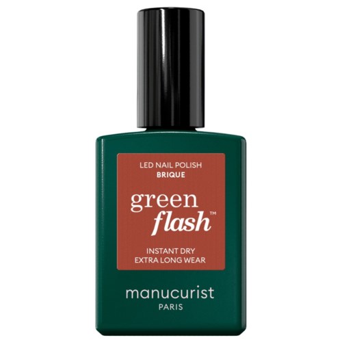 A green bottle of nail polish, labeled green flash, with a black cap. It says LED nail polish with quick dry.