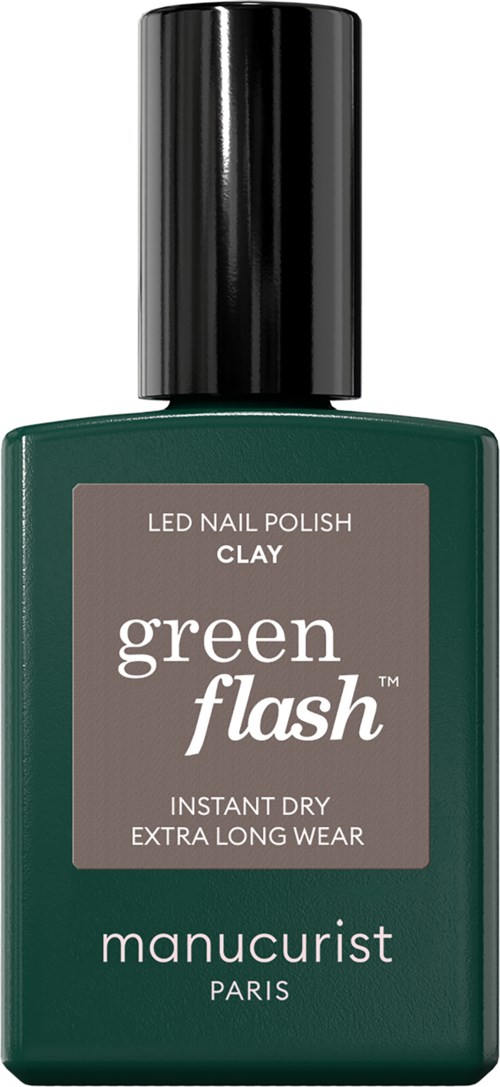 A green bottle of nail polish with a black cap, labeled 'Green Flash' and 'Clay,' by manucurist Paris.