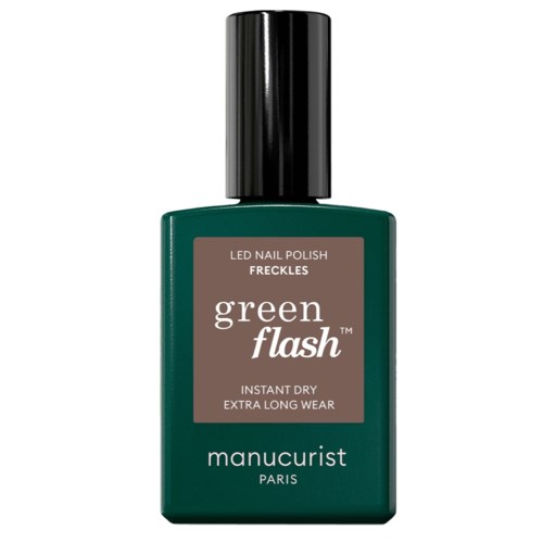 Green nail polish bottle with a black cap, labeled as Freckles Green Flash for long wear.
