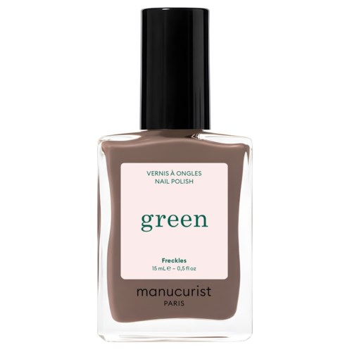 A bottle of green nail polish labeled 'Freckles' by Manucurist Paris, with a black cap.