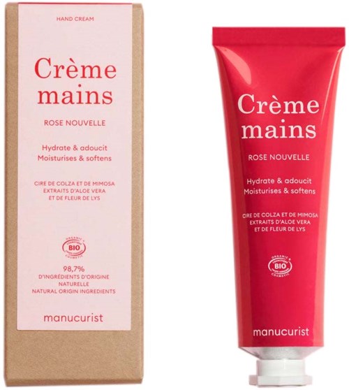 Röd handkrämstub med vit topp bredvid beige box med rosa och röd text för Manucurist handkräm.