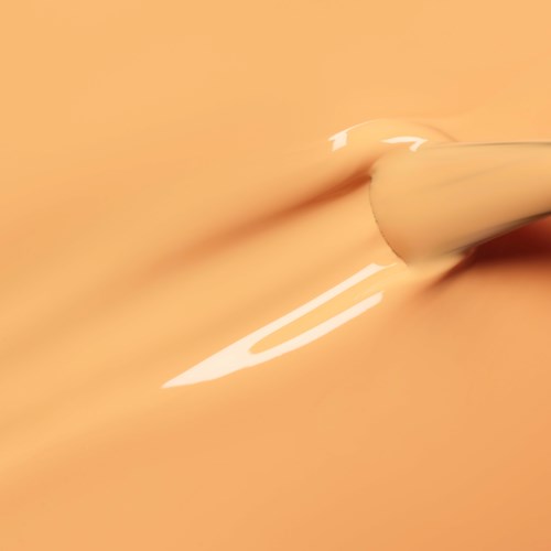 A close-up of a needle-like pen writing on a peach-colored paper.