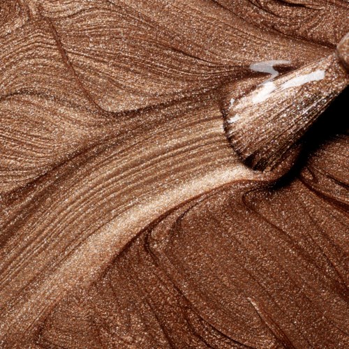 Närbild av brunt, skimrande ögonskugga med slät, blandad textur.
