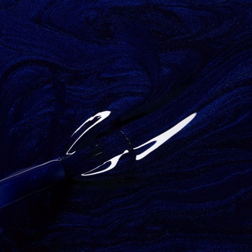 A pen writes white ink on a dark, swirling background, creating elegant and flowing lines.