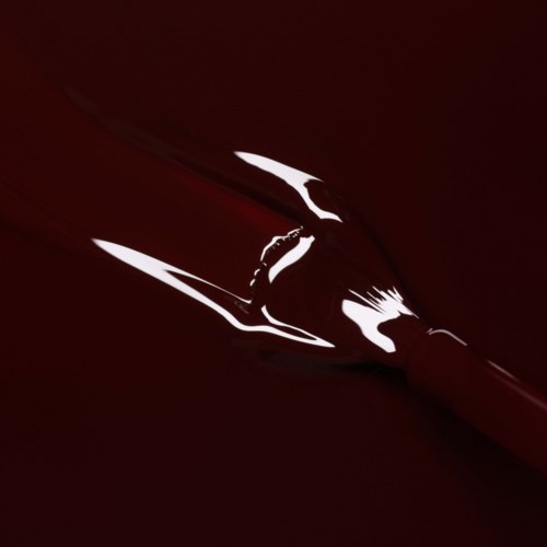 A red pen with a silver clip, resting on a dark background, highlighting its shiny surface and sleek design.
