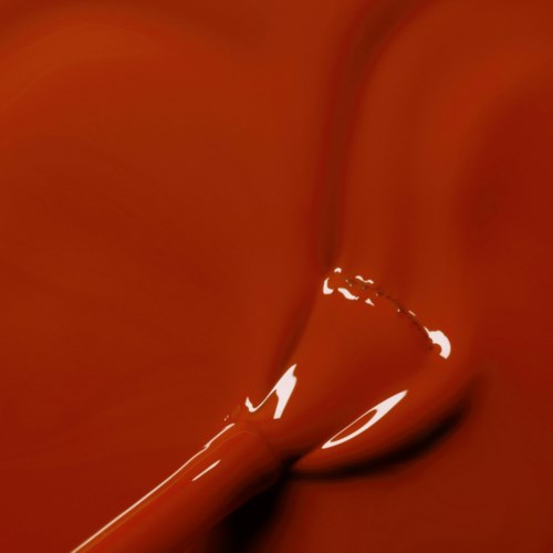 A stream of milk is pouring into a cup of chocolate, creating swirls and a creamy splash.